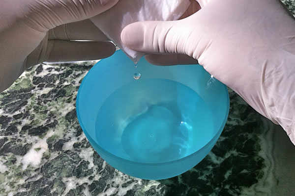 Squeeze excess water from toweling